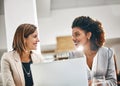 Making the climb to the top together. two businesswomen working together on a laptop in an office. Royalty Free Stock Photo