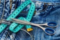 Making clothes and design concept: tailors tools on denim textile. Royalty Free Stock Photo