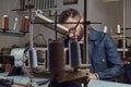 Making clothes. tailor sitting at table and working on a sewing machine at the sewing workshop. Royalty Free Stock Photo