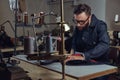 Making clothes. tailor sitting at table and working on a sewing machine at the sewing workshop. Royalty Free Stock Photo