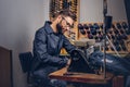 Making clothes. tailor sitting at table and working on a sewing machine at the sewing workshop. Royalty Free Stock Photo