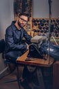 Making clothes. tailor sitting at table and working on a sewing machine at the sewing workshop. Royalty Free Stock Photo