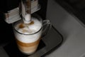 Making coffee in a coffee machine at home. Boil and beat process. The finished coffee has three layers of white, beige