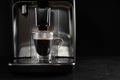 Making coffee with modern espresso machine on grey table against black background. Space for text Royalty Free Stock Photo