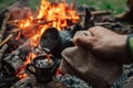 Making coffee process on the campfire. Man pour coffe in potter