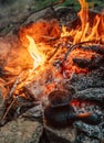 Making coffee process on campfire. Turkish cezva near open fire
