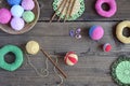 Making colored crochet balls. Toy for babies and toddlers to learn mechanical skills and colors. On the table threads, needles, Royalty Free Stock Photo