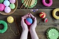 Making colored crochet balls. Toy for babies and toddlers to learn mechanical skills and colors. On the table threads, needles, Royalty Free Stock Photo