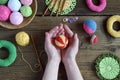 Making colored crochet balls. Toy for babies and toddlers to learn mechanical skills and colors. On the table threads, needles, Royalty Free Stock Photo