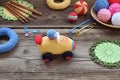 Making colored crochet racing car. Toy for babies and toddlers to learn mechanical skills and colors. On the table threads, Royalty Free Stock Photo