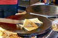 Making crepes pancakes at a market. A crepes is folded up