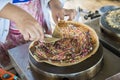 Making of crepes pancakes in open thailand street market.crepes with chocolate sauce and chopped nuts for a tasty dessert.Japanese