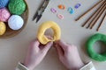 Making crochet pyramid from colored rings. Toy for babies and toddlers to learn mechanical skills and colors. On the table threads Royalty Free Stock Photo