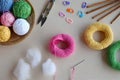 Making crochet pyramid from colored rings. Toy for babies and toddlers to learn mechanical skills and colors. On the table threads Royalty Free Stock Photo