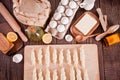 Making croissants at home. Rolls the dough into rolls for further baking. Ingredients and kitchen utencil on the Royalty Free Stock Photo