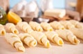 Making croissants at home. Rolls the dough into rolls for further baking. Ingredients and kitchen utencil on the Royalty Free Stock Photo