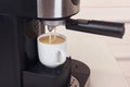 Making cup of espresso in carob coffee maker Royalty Free Stock Photo