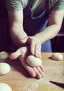 Making daugh balls on the wooden table to bake buns