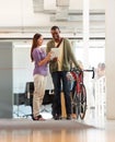 Making the days deliveries. Full length shot of a handsome bike messenger in an office.