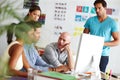 Making decisions together. A group of colleagues gathered around a computer in the office. Royalty Free Stock Photo