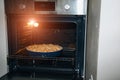 Making desserts at home. Apple pie in the open oven for baking