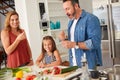 Making dinner prep a family affair. an adorable little girl cooking with her mother and father at home. Royalty Free Stock Photo