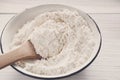 Making dough, baking. Bowl with flour on wood desk Royalty Free Stock Photo