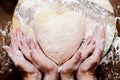 Making dough from eggs and milk. Heart shaped dough with female and child hands. Cooking and home concept Royalty Free Stock Photo