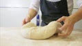 Making dough by male hands at bakery