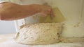 Making dough by male hands at bakery