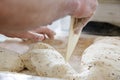 Making dough by male hands at bakery