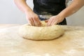 Making dough by male hands at bakery