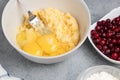 Making a dough for a sweet cranberry pie. Adding eggs Royalty Free Stock Photo