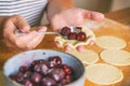 Making dumplings filled with sour cherry with sugar