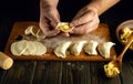 Making dumplings at home. Close-up of a man hands making dumplings from dough Royalty Free Stock Photo