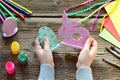 Making Easter decoration - easter eggs and bunny. Painting and coloring wooden toy of brushes and gouache. Creative process.