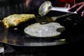 Making of egg roll on a hot frying pan with oil and paratha and salad Royalty Free Stock Photo