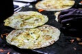 Making of egg roll on a hot frying pan with oil and paratha and salad Royalty Free Stock Photo