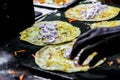 Making of egg roll on a hot frying pan with oil and paratha and salad Royalty Free Stock Photo