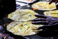 Making of egg roll on a hot frying pan with oil and paratha and salad Royalty Free Stock Photo