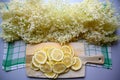 making elderflower lemonade with lemons in kitchen