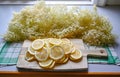 making elderflower lemonade with lemons in kitchen