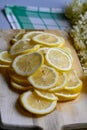 making elderflower lemonade with lemons in kitchen