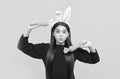 making faces. funny child in hare ears hold carrot. teenager girl wear rabbit costume Royalty Free Stock Photo