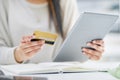 Making a few quick swipes online. Closeup shot of an unrecognisable businesswoman using a digital tablet and credit card Royalty Free Stock Photo
