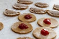 Making, filling and folding brown jam filled cookies