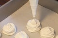 Making French meringue cookies on parchment paper