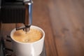 Making fresh aroma coffee with espresso machine in cold evening Royalty Free Stock Photo