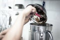 Making gelato ice cream with modern equipment in kitchen interior