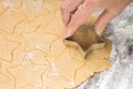 Making ginger bread christmas cookies with metal cutter. Ginger dough and flour Royalty Free Stock Photo
